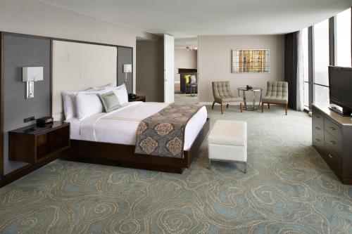 a hotel room with a bed and a television at Detroit Marriott at the Renaissance Center in Detroit