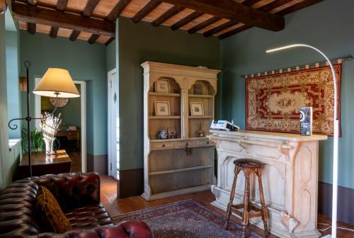 a living room with a fireplace and a couch at Agriturismo San Rocco in Pistoia