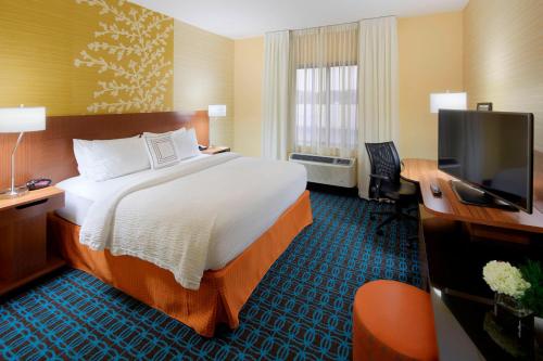 a hotel room with a bed and a television at Fairfield Inn & Suites by Marriott Springfield Northampton/Amherst in Northampton