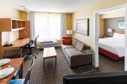 a hotel room with a bed and a desk at TownePlace Suites Los Angeles LAX Manhattan Beach in Hawthorne