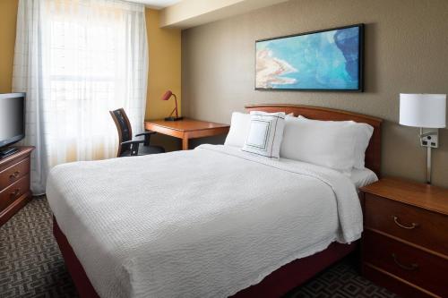 a hotel room with a bed and a television at TownePlace Suites Los Angeles LAX Manhattan Beach in Hawthorne