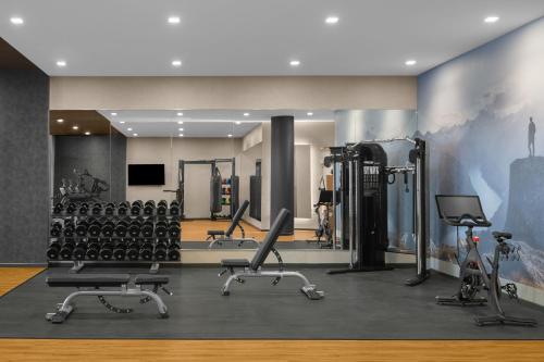 a gym with treadmills and exercise equipment in a room at AC Hotel by Marriott Vancouver Waterfront in Vancouver