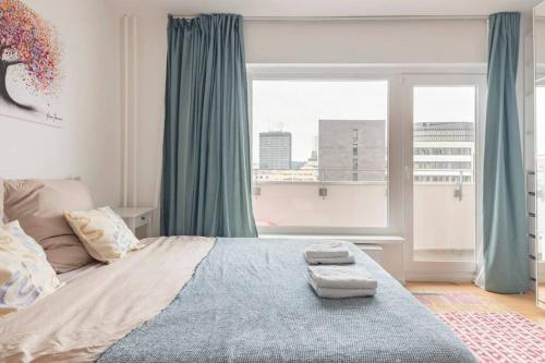 a bedroom with a bed and a large window at Modern Home in Central Berlin in Berlin