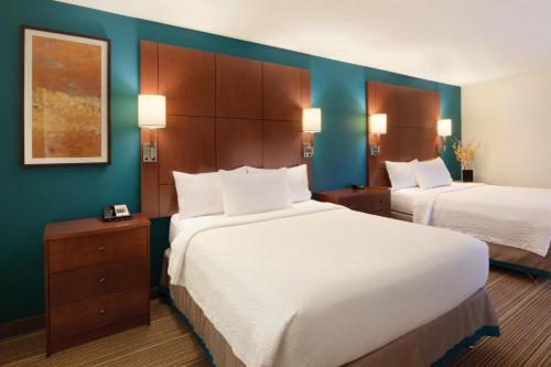 a hotel room with two beds and blue walls at Residence Inn Bismarck North in Bismarck