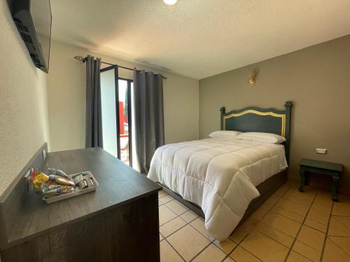 Postel nebo postele na pokoji v ubytování Hotel Casa Real Cholula