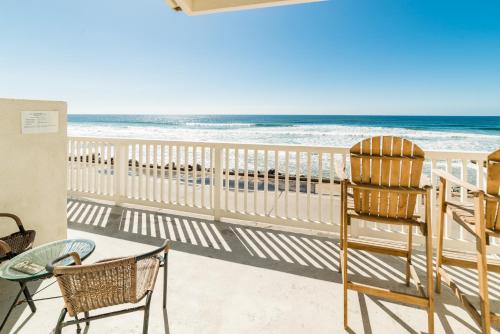 a balcony with a view of the beach at Pacific Villas in Oceanside
