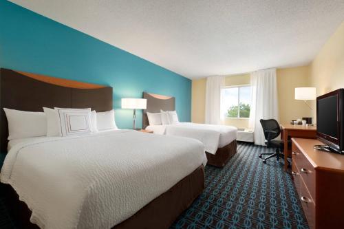 a hotel room with two beds and a television at Fairfield Inn Kankakee Bourbonnais in Bourbonnais