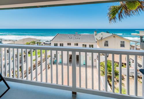 a view of the beach from the balcony of a house at Pacific Villas in Oceanside