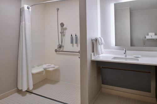 a bathroom with a shower and a sink at Residence Inn by Marriott Detroit / Novi in Novi