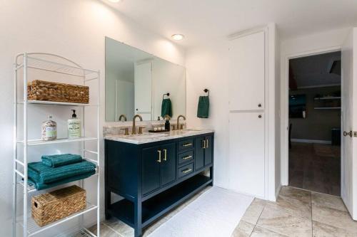 a bathroom with a blue sink and a mirror at Modern Beach Oasis in San Diego