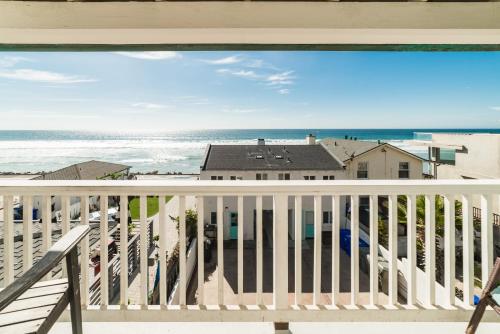a view of the beach from the balcony of a beach house at Pacific Villas in Oceanside