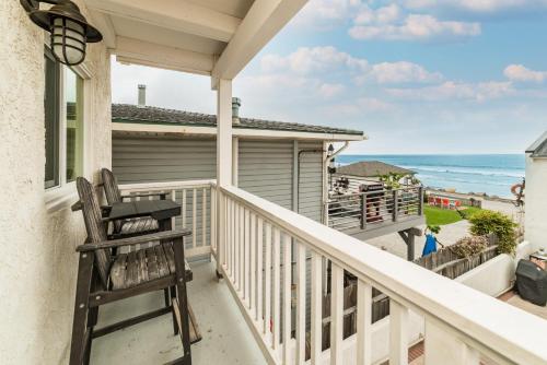 a rocking chair sits on a balcony overlooking the ocean at Pacific Villas in Oceanside