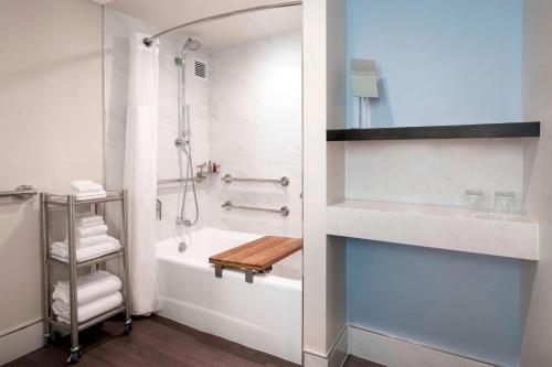 a bathroom with a shower and a bath tub at Irvine Marriott in Irvine