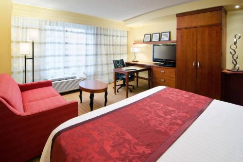 a hotel room with a bed and a television at Courtyard by Marriott Birmingham Downtown at UAB in Birmingham