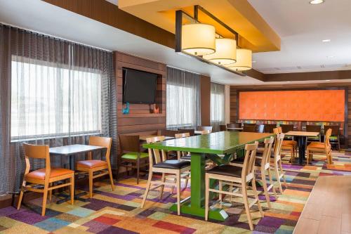 a conference room with tables and chairs and a tv at Fairfield Inn & Suites Grand Rapids in Grand Rapids