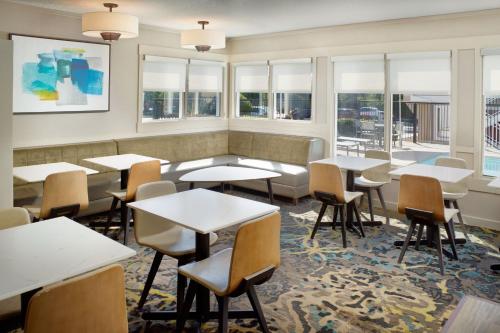 a restaurant with tables and chairs and windows at Residence Inn by Marriott Atlanta Buckhead in Atlanta