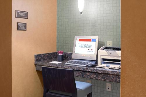a computer sitting on a desk with a printer at Residence Inn by Marriott Dallas Plano/Legacy in Plano