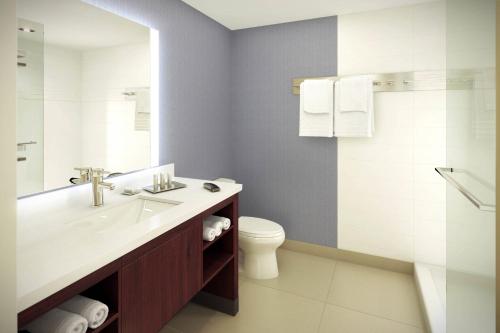 a bathroom with a sink and a toilet at Residence Inn by Marriott Los Angeles LAX/Century Boulevard in Los Angeles