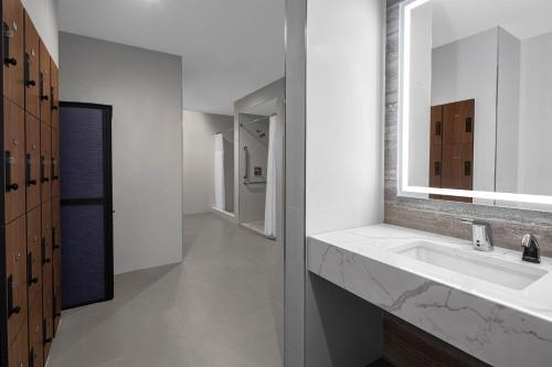 a bathroom with a sink and a mirror at Four Points by Sheraton Flushing in Queens