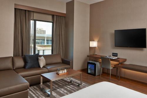 a living room with a couch and a table at AC Hotel by Marriott Minneapolis Downtown in Minneapolis