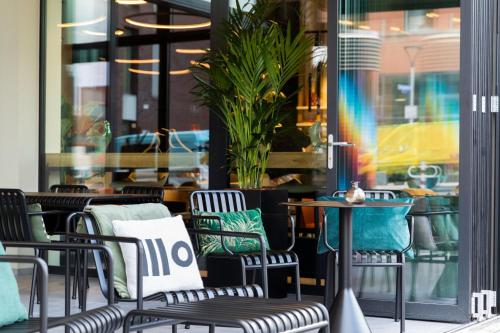 a group of chairs and tables in front of a store at Residence Inn by Marriott Dortmund City in Dortmund