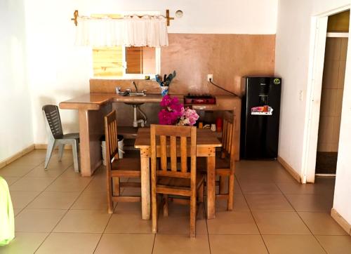 a kitchen and dining room with a table and chairs at Nexpa cabañas Martha surf spot in Caleta de Campos