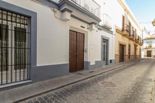 a cobblestone street in an alley with buildings at Top & Chic Albarizuela Suites - Apartamentos Jerez in Jerez de la Frontera