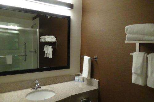 a bathroom with a sink and a mirror and towels at Fairfield Inn & Suites by Marriott Atlanta Buford/Mall of Georgia in Buford