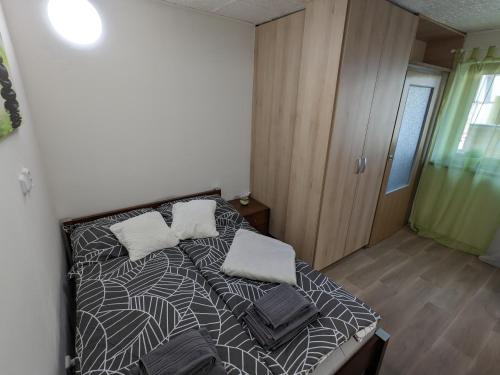 a bedroom with a bed with two pillows on it at Útulné studio u Mariánského údolí v Brně - Líšni in Líšeň