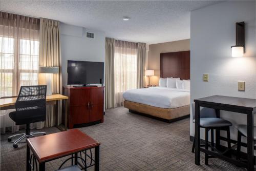 a hotel room with a bed and a desk at Residence Inn by Marriott Little Rock in Little Rock