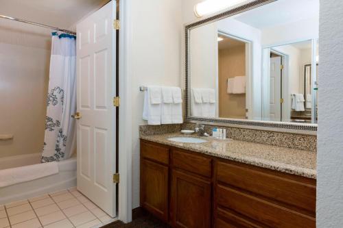 a bathroom with a sink and a mirror at Residence Inn Kansas City Olathe in Olathe