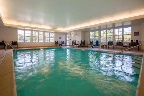 a large swimming pool with blue water in a building at Residence Inn Kansas City Olathe in Olathe