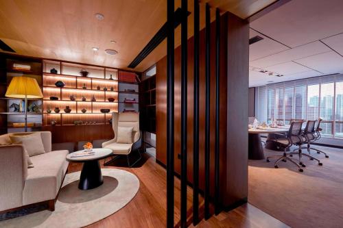 an office with a desk and chairs and a table at Renaissance Kuala Lumpur Hotel & Convention Centre in Kuala Lumpur
