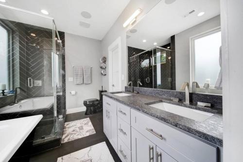 a bathroom with two sinks and a shower at City Views - Walking Distance to Panthers Stadium in Charlotte
