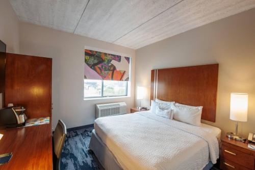 a hotel room with a bed and a window at Fairfield Inn & Suites By Marriott New York Brooklyn in Brooklyn