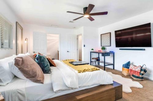 a bedroom with a large bed with a ceiling fan at The Castle House Estate in Joshua Tree