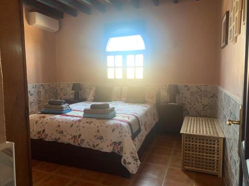 a bedroom with a bed in a room with a window at Private villa large pool elevated quiet secluded location, near Mojacar in Antas