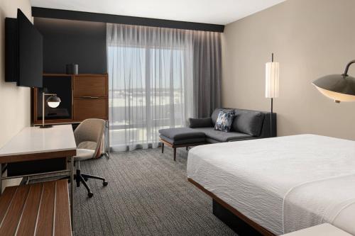 a hotel room with a bed and a desk at Courtyard by Marriott Houston I-10 West/Memorial in Houston