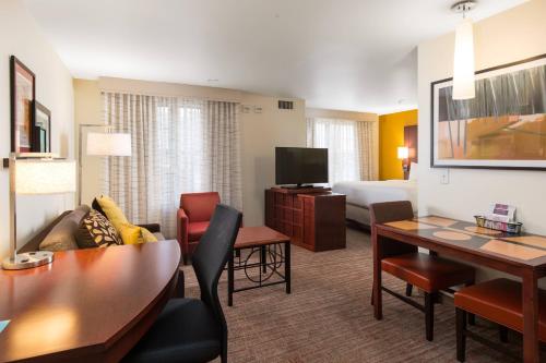 a living room with a couch and a table in a hotel room at Residence Inn by Marriott Springfield Old Keene Mill in Springfield