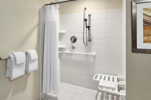 a bathroom with a shower with a shower curtain at Courtyard Shreveport-Bossier City/Louisiana Boardwalk in Bossier City