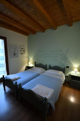 MedunoにあるAgriturismo Ai Pradonsの部屋にベッドが2つある寝室