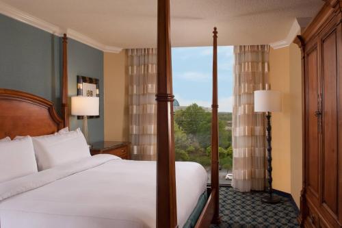 a bedroom with a bed and a large window at Greenville Marriott in Greenville