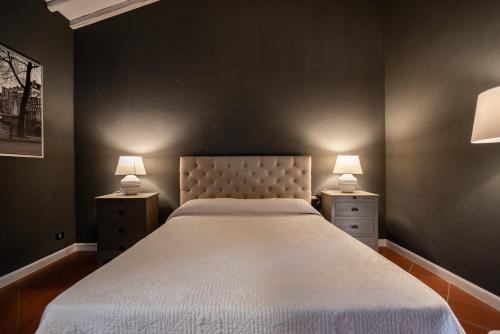 a bedroom with a large bed with two night stands at Relais La Martina in Pietraviva