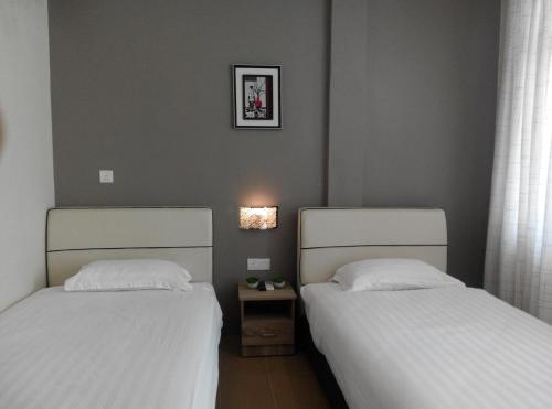 Ένα ή περισσότερα κρεβάτια σε δωμάτιο στο Welcome Inn GM