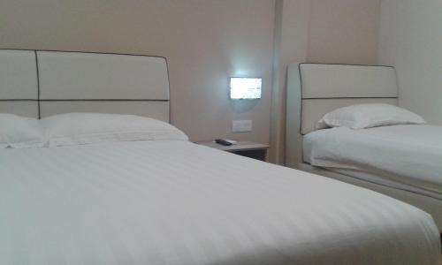 Postel nebo postele na pokoji v ubytování Welcome Inn GM