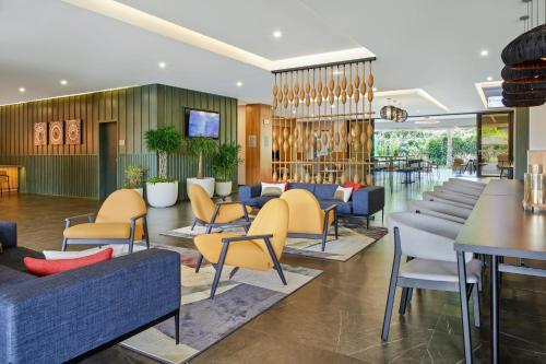 a lobby with couches and tables and chairs at Courtyard by Marriott San Jose Escazu in San José