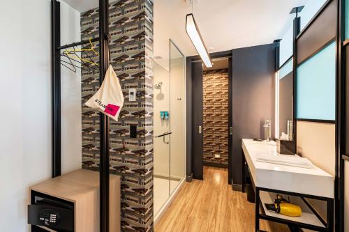 a bathroom with a wall of wine bottles at Aloft Savannah Downtown Historic District in Savannah