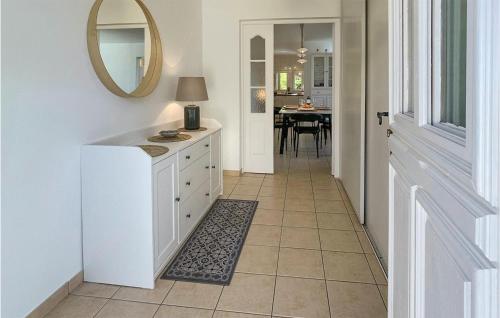a kitchen with a white cabinet and a mirror at Cozy Apartment In Mauléon D'armagnac in Mauléon-dʼArmagnac