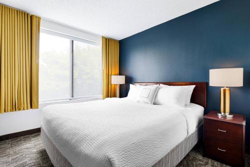 a bedroom with a bed and a large window at SpringHill Suites by Marriott Richmond North/Glen Allen in Richmond