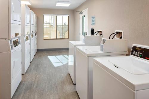 a bathroom with white sinks and white appliances at Residence Inn by Marriott San Diego Chula Vista in Chula Vista